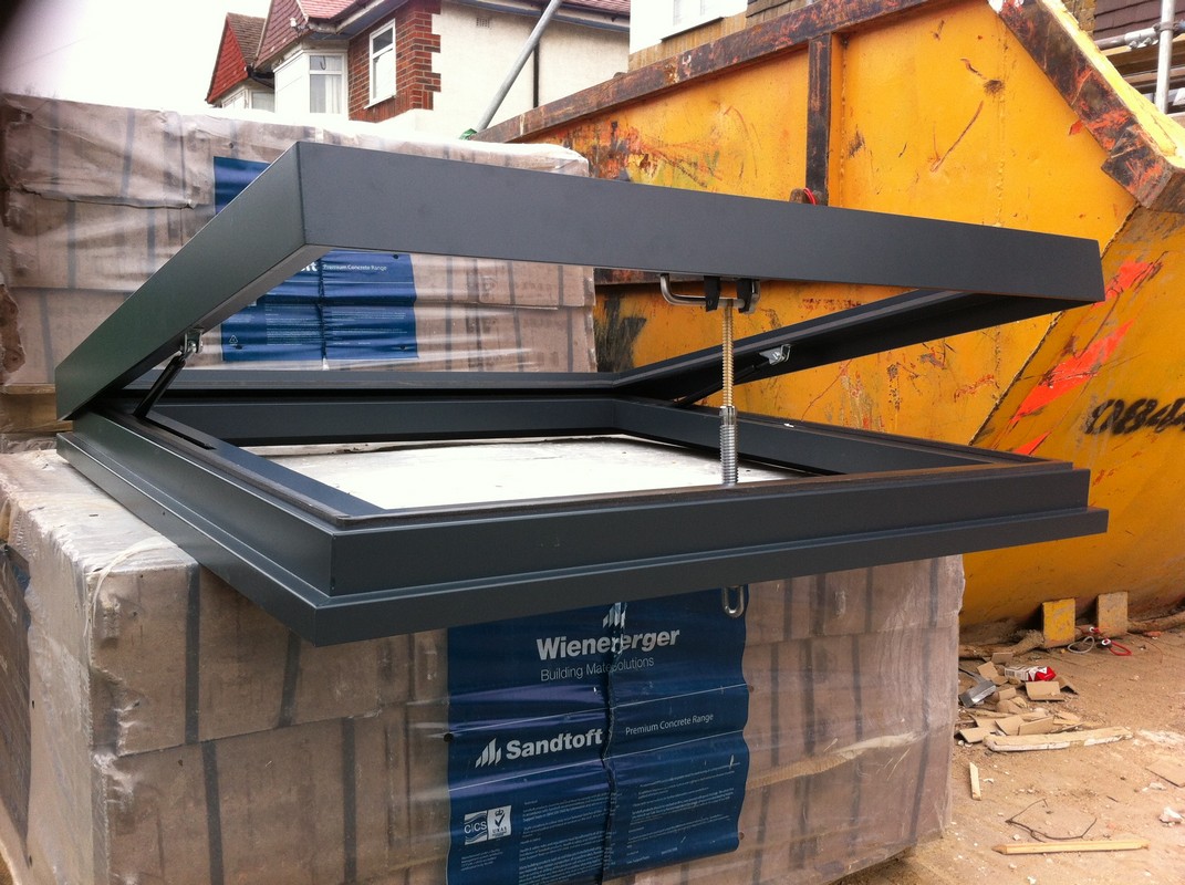 Opening flat roof skylight in anthracite grey installed in Waltham Abbey